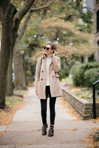 cream-colored cable knit sweater, black hiking boots