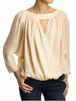 cream-colored keyhole blouse with black skinny jeans