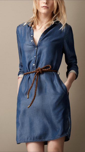 dark blue long sleeve tunic with button placket on the front and unwashed denim