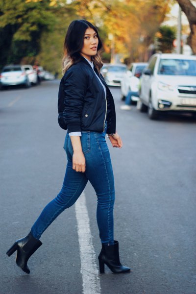 dark blue short bomber jacket with jeans and boots