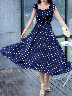 Dark blue maxi dress with a dotted fit and a flared maxi dress with silver heels