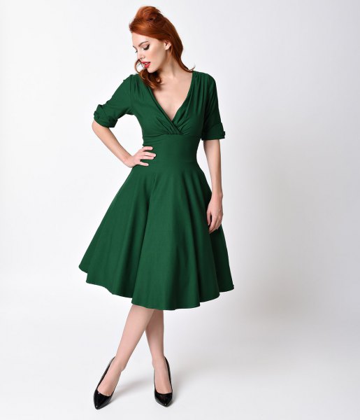 dark green swing dress with deep V-neck in the style of the 1950s