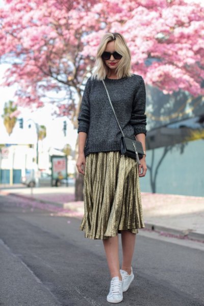 dark gray knitted sweater, gold pleated skirt