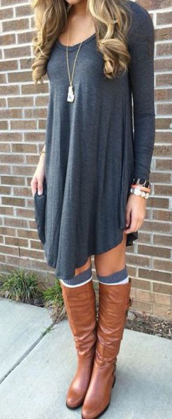dark gray long-sleeved swing dress with brown leather boots