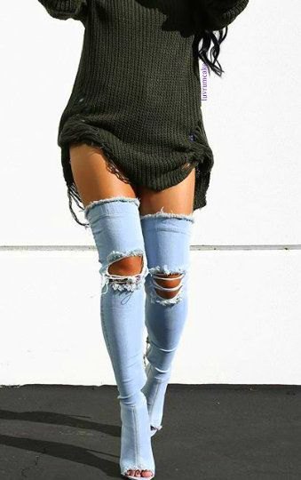 dark gray, torn sweater dress with long, open toe boots made of blue denim