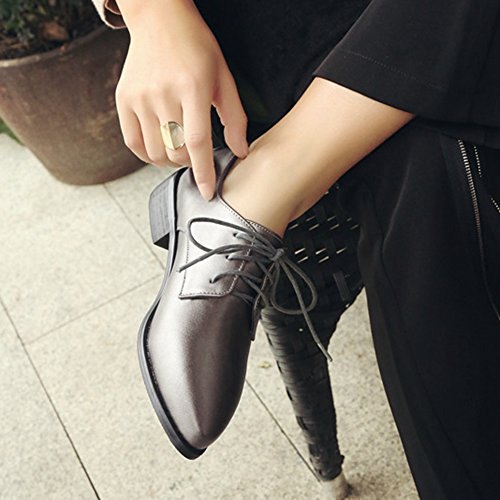 dark high-heeled leather shoes with black chinos with straight legs