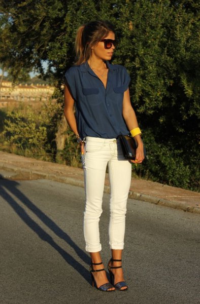 Dark blue sleeveless blouse with white jeans with cuffs