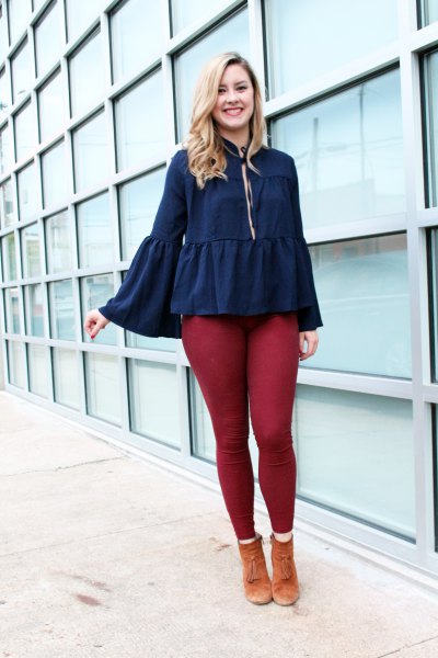 deep blue ruffled blouse with bell sleeves and green leggings
