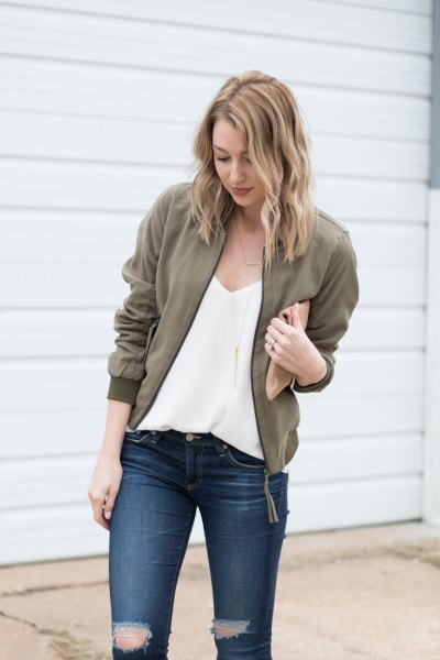 deep chiffon blouse with V-neckline, olive green jacket and ripped jeans