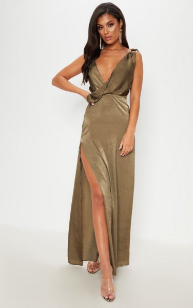 deeply slit khaki maxi dress with deep V-neckline and silver, open toe heels