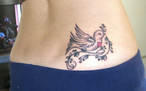 Dove and grapevine tattoo on hip