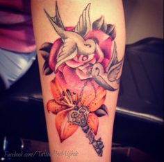 Dove with lily tatto on her arm