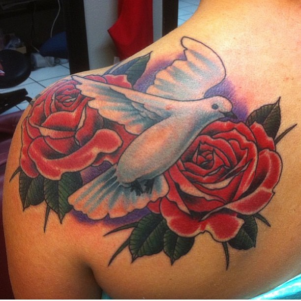 Dove with a rose tattoo on the shoulder
