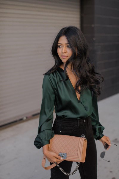 Emerald green long-sleeved silk top with black skinny jeans