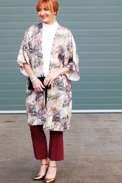 Flora printed long cape with red flared trousers and bronze heels