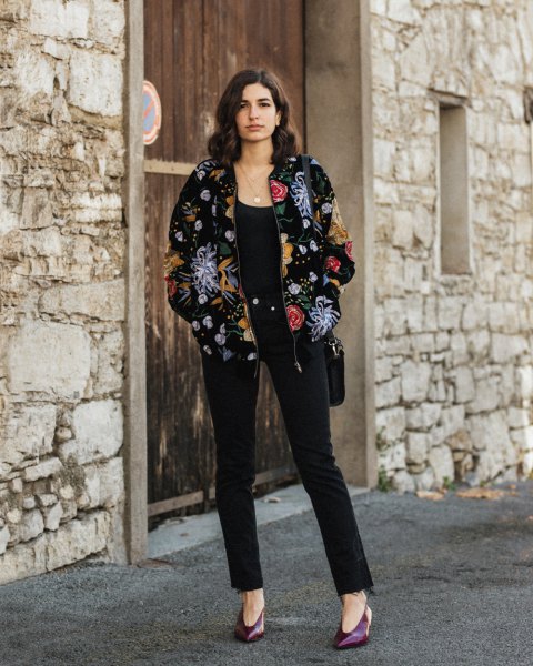 Velvet bomber jacket with a floral pattern and black ankle jeans