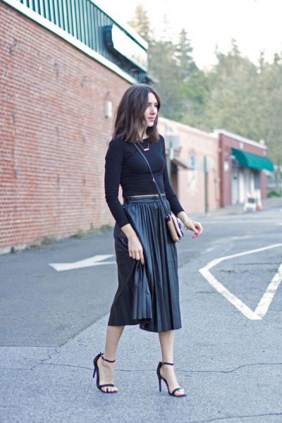 Figure-hugging, shortened knitted sweater with black pleated midi skirt