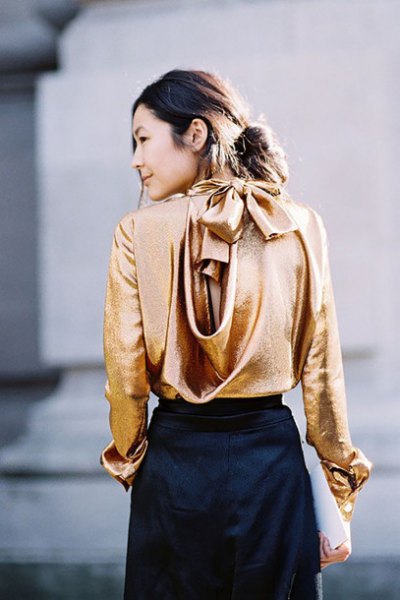 Metallic blouse with gold waterfall neckline and black mini skirt