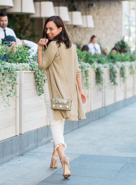 golden longline cardigan with white, narrow-cut jeans