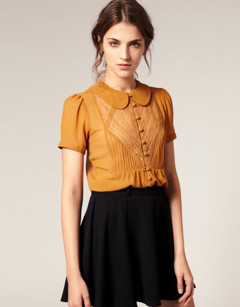 golden short-sleeved blouse with round collar and buttons and black mini skirt