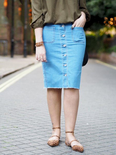 green buttonless blouse with a knee-length skirt with blue denim button on the front