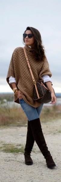 green cable pattern poncho sweater with black overknee boots