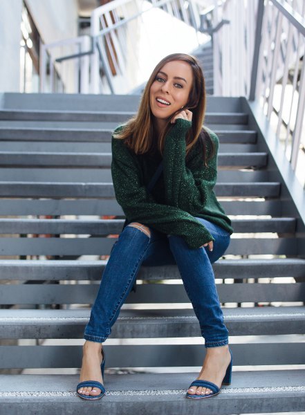 green, chunky sweater with blue ripped skinny jeans
