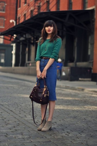 green knitted sweater with a high-waisted midi denim skirt