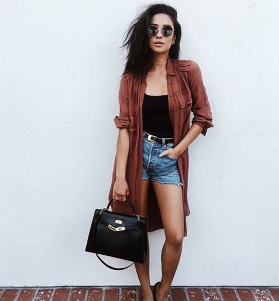 green long trench coat with black vest and high-waisted denim shorts