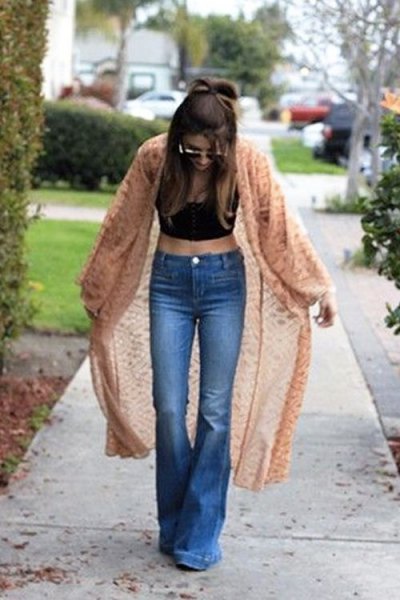 Green midi cardigan with black crop top and flared jeans