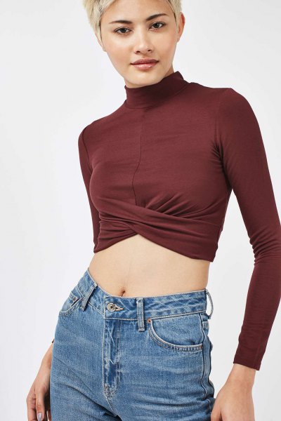 green long-sleeved crop top with mock neck and blue jeans