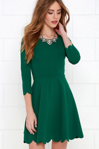 green skater cocktail dress with scalloped hem and three-quarter sleeves