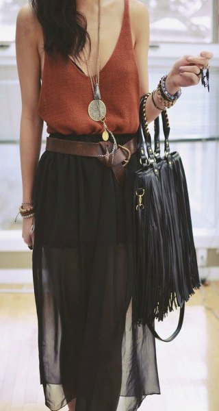 green vest top with scoop neckline, black chiffon midi skirt and leather bag with fringes