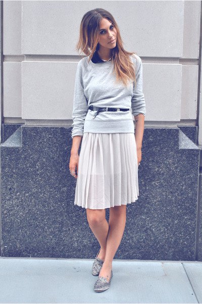 gray sweater with relaxed fit and knee-length pleated skirt and silver slippers with spikes