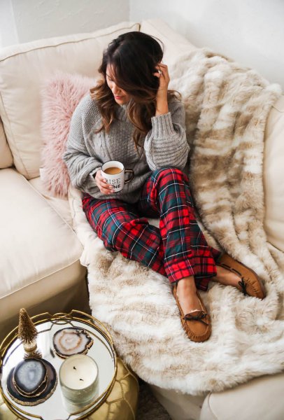 gray cable knit sweater with red and blue checked pajama pants