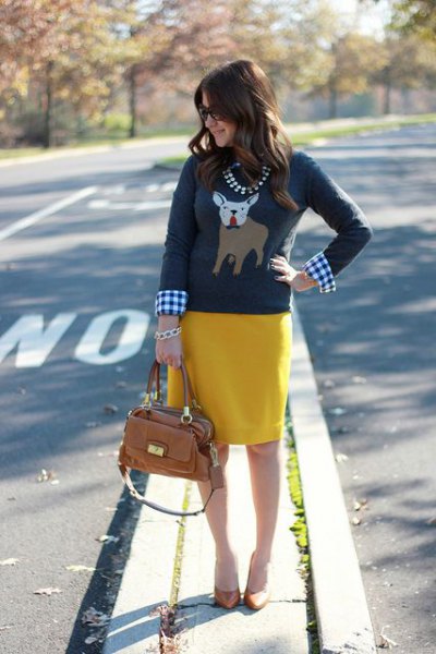 gray Christmas graphic sweater with plaid shirt and yellow skirt