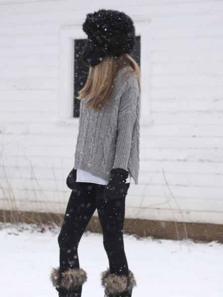 gray, coarse-grained knitted sweater with knee-high boots made of faux fur