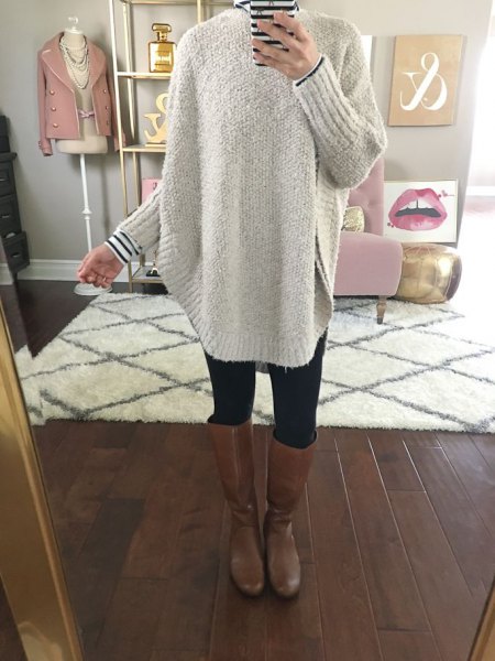 gray, chunky sweater with a striped T-shirt and knee-high leather boots