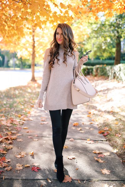 gray tunic sweater with cold shoulder and black leather leggings