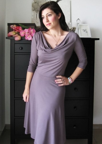 gray dress with a cowl neckline and a flared dress