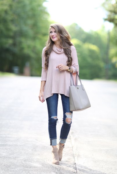 gray three-quarter sleeved sweater with a cowl neckline and ripped jeans with cuffs