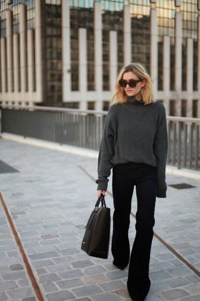 gray, thick sweater with a round neckline and black, flared jeans