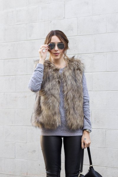 gray sweater with round neckline and brown faux fur vest