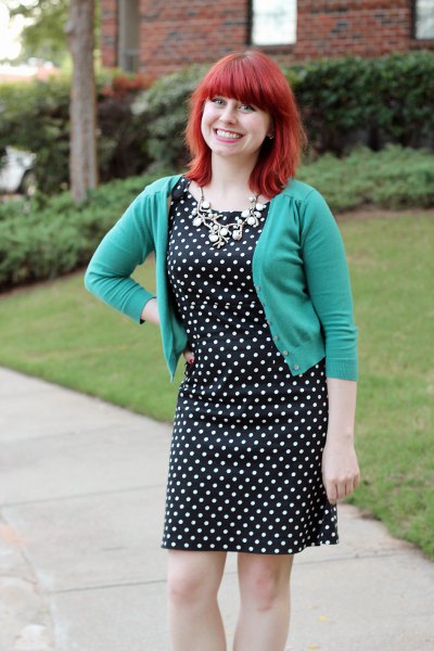 gray, short cut cardigan with a black and white polka dot dress