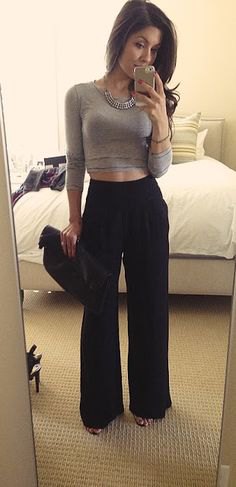 gray, cropped, long-sleeved, figure-hugging t-shirt with black pants with a high waist and wide legs