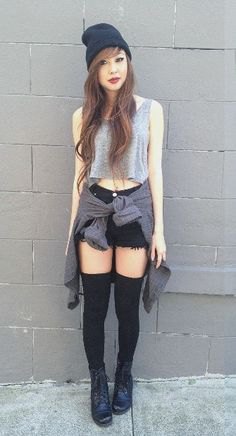 gray short tank top with black mini denim shorts and boots