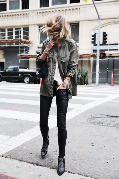 gray denim jacket with black leather gaiters and boots with ankle spikes