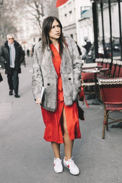 gray faux fur coat with an orange midi dress and white hiking tennis shoes