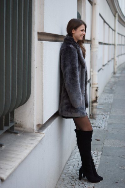 gray faux fur coat with black thigh high boots
