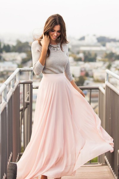 gray, figure-hugging knitted sweater with white, floor-length, flowing skirt